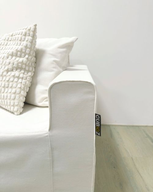 Detail of slipcover with rounded armrest for cardboard armchair.